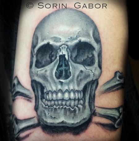 Sorin Gabor - Realistic black and opaque gray skull tattoo on forearm